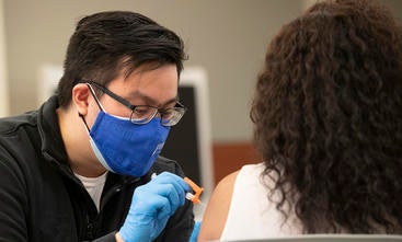 Medical student giving a COVID vaccination