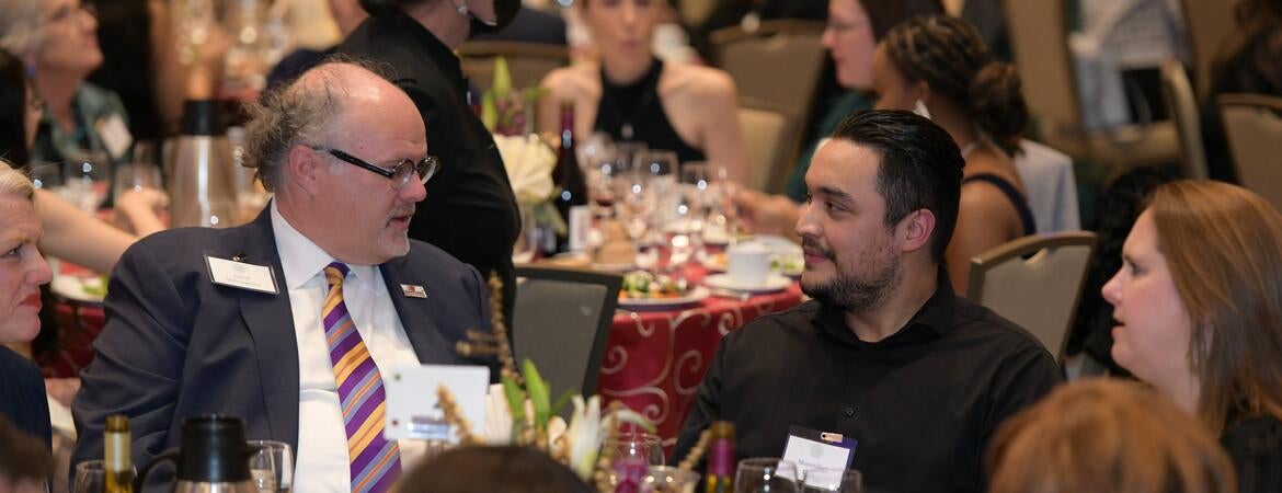 Jarrod McNaughton speaking to a student at the 2022 Gala