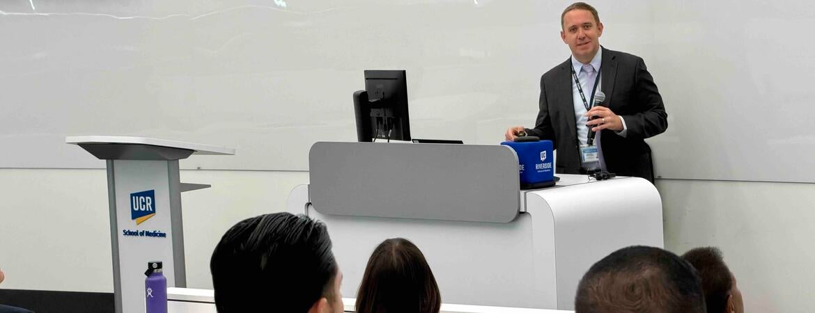 Meth summit attendees sitting at tables listening to the keynote speaker