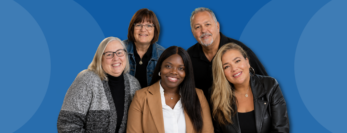 Office of Faculty Development group photo against a blue background
