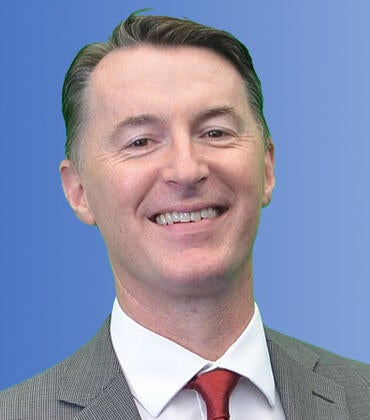 Declan McCole in front of a blue background