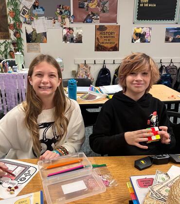 Two Craig School Students working at a table
