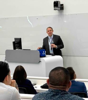 Meth summit attendees sitting at tables listening to the keynote speaker