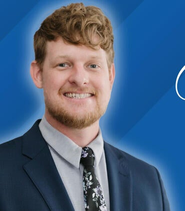 Headshot of Andrew McLain on a blue background next to text reading "Class of 2026"