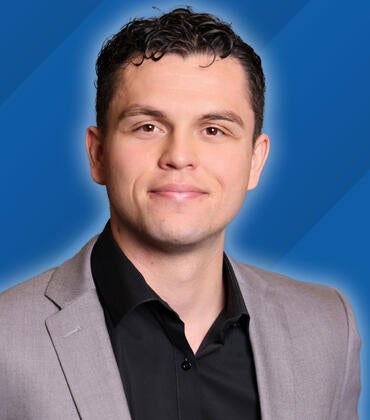 Headshot of Javier Prieto on a blue background next to text reading "Class of 2026"