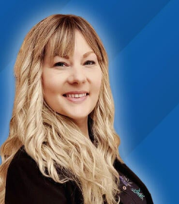 Headshot of Alicia Junker on a blue background next to text reading "Class of 2026"