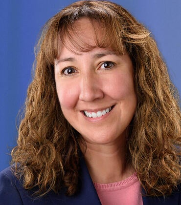 Dr. Christina Granillo on a blue background