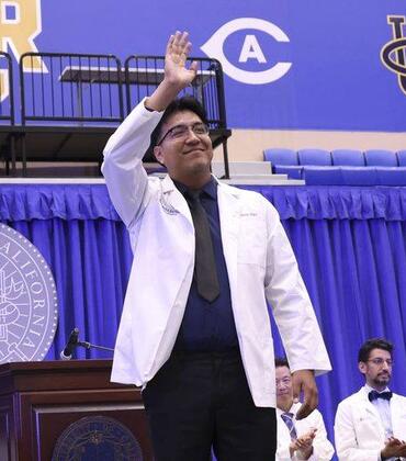 Carlos Diaz waves during the 2026 white coat ceremony