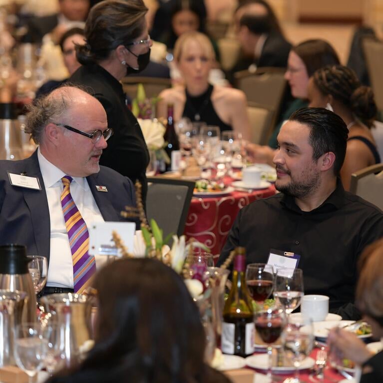 Jarrod McNaughton speaking to a student at the 2022 Gala