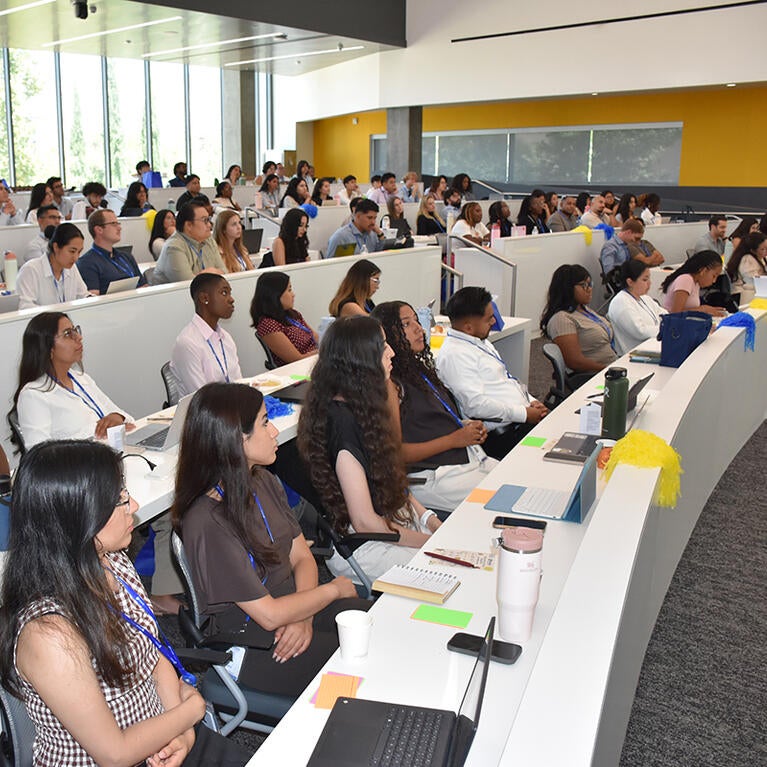 Medical students listen durin orientation