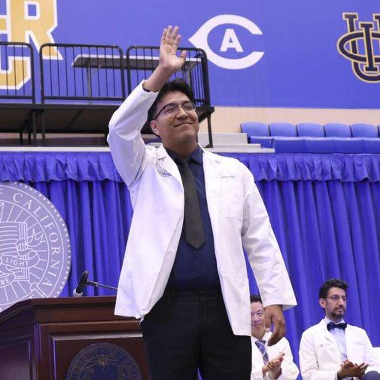 Carlos Diaz waves during the 2026 white coat ceremony