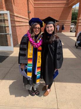 Elena Guardado with Dr. Erika Heinrich at her hooding ceremony.