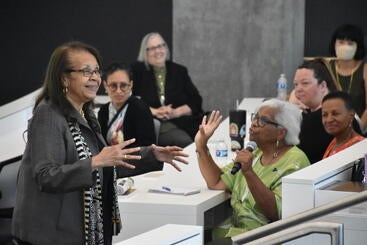 Dr. Malcom talking to Dr. Yolanda Moses