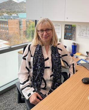 Iryna Ethell sitting at her desk