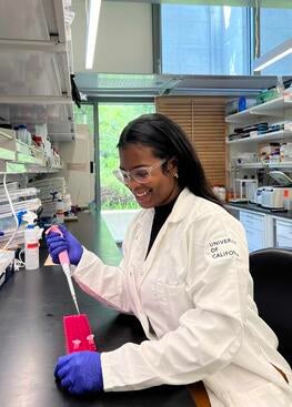 Keziyah Yisrael wearing a white coat in the lab