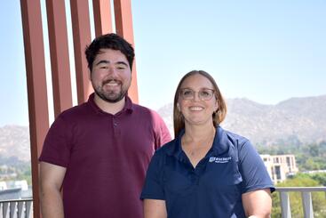 kate-brian-2025 Brian Blackburn and Kate Dorff standing next to each other on the terrace in the SOM Ed II building