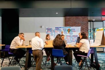 UC BRAID retreat participants sitting around a table