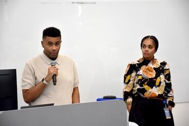 Second-year medical student Emmanuel Scaife introduces Dr. Gabrielle Pina