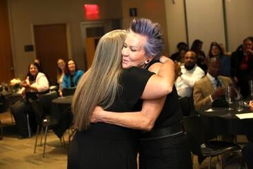 KA Aguilar receives a hug after getting her award