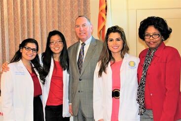 Class of 2018 students Katherine Tsai, MD, Mayra Hernandez Schulte, MD, and Morvarid Tavassoli, MD, with retired California Senator Richard Roth and Desiree Reedus, MD, MPH,  at the Doctor's Corner Woman's  Community Symposium at the Riverside Woman's Club