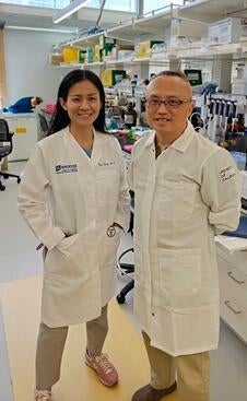 Joy Xiang and Rong Hai standing in the lab