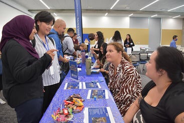 Dr. Denise Martinez and Angelina Vanle speaking to a student at orientation