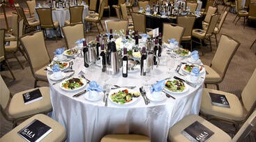 A table at the 2026 gala plated with salads and the gift of olive oil