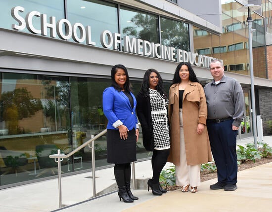 Facilities team in front of the Ed II building