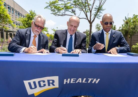 ucrhealth_signing_event Garry Spanner, president of Canyon Springs Marketplace Corp, UCR Chancellor Kim Wilcox, and UC President Michael V. Drake sign a letter of intent. Photo by Stan Lim
